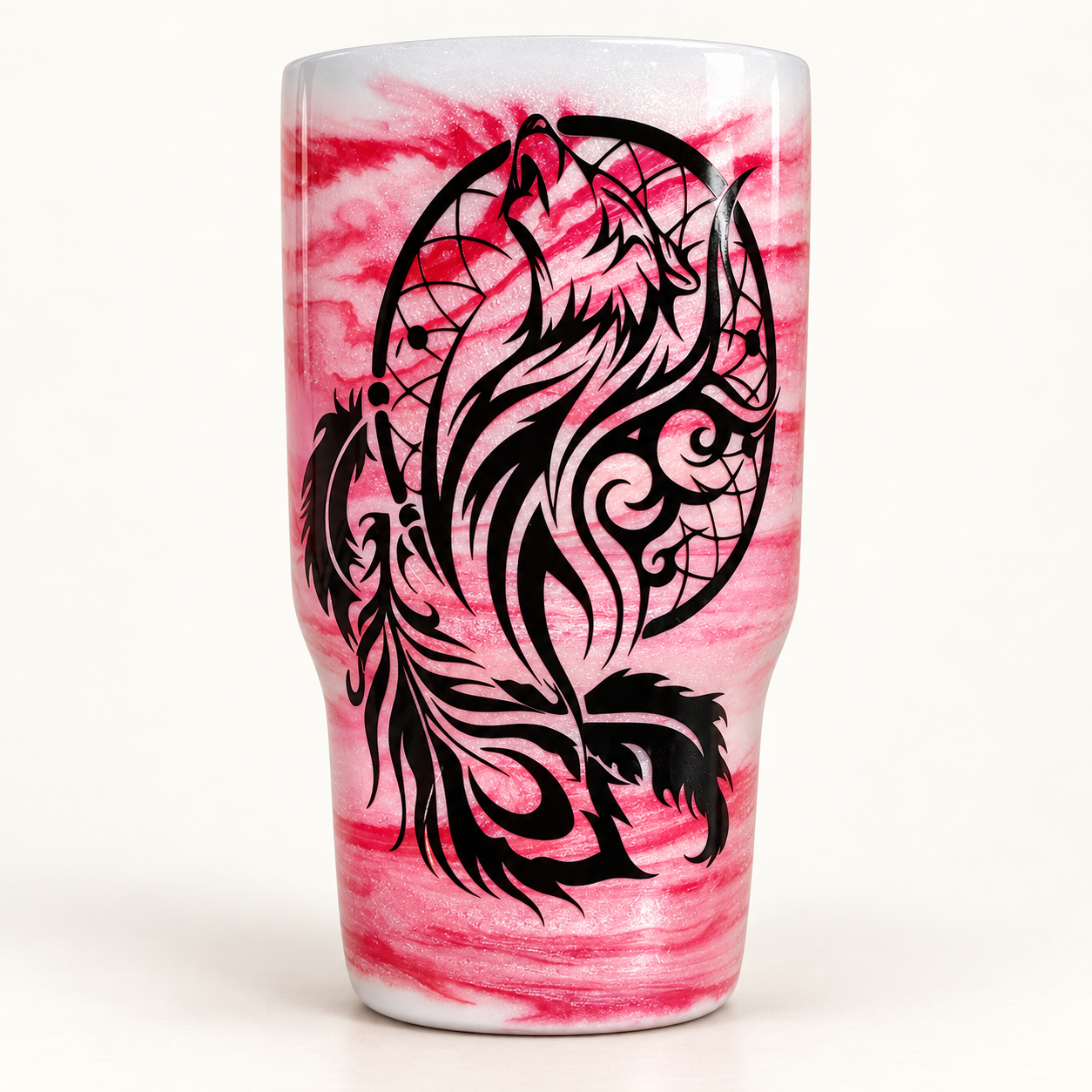 A pink marbled glitter tumbler with a black howling wolf and dreamcatcher design